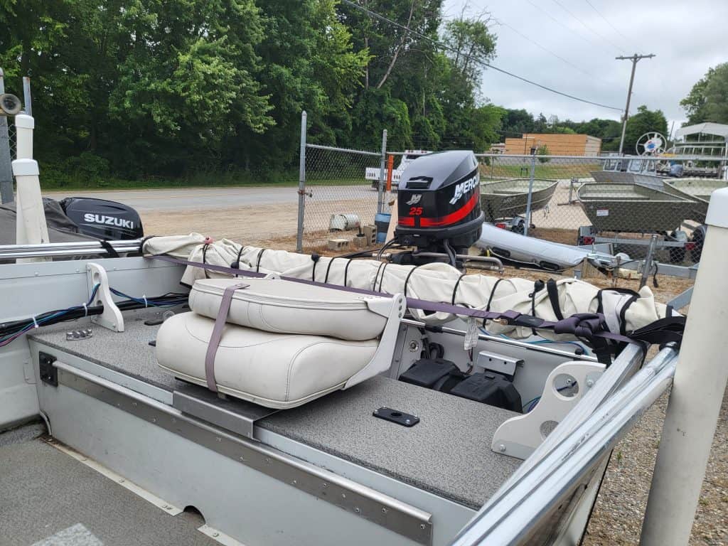 Used Sylvan 14 utility boat with Mercury outboard motor and seating.