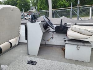 Boat dashboard with steering wheel and controls for Sylvan 14 utility boat.
