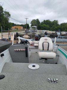 Used Sylvan 14 utility boat with seating and motor, ideal for fishing and leisure.