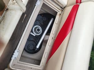 Fish finder device installed in boat storage compartment.
