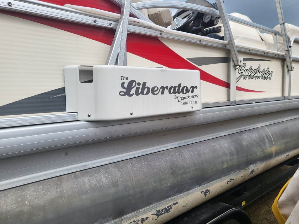 Sweetwater 23 Fish pontoon boat with The Liberator by Jackson on the side.