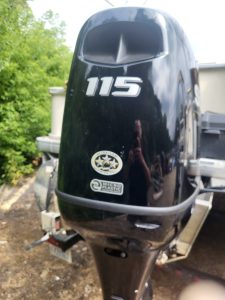 Black 115 horsepower outboard motor for boats by Camp and Cruise.