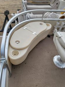 Boat deck with built-in cooler and storage for fishing gear.
