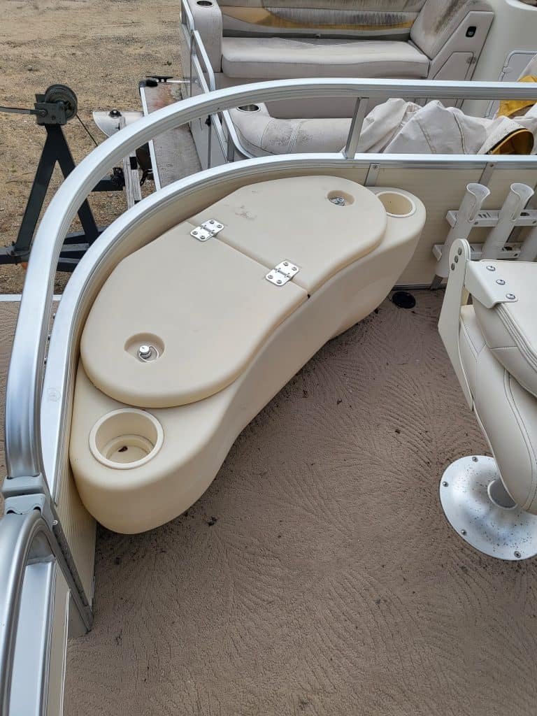 Boat deck with built-in cooler and storage for fishing gear.