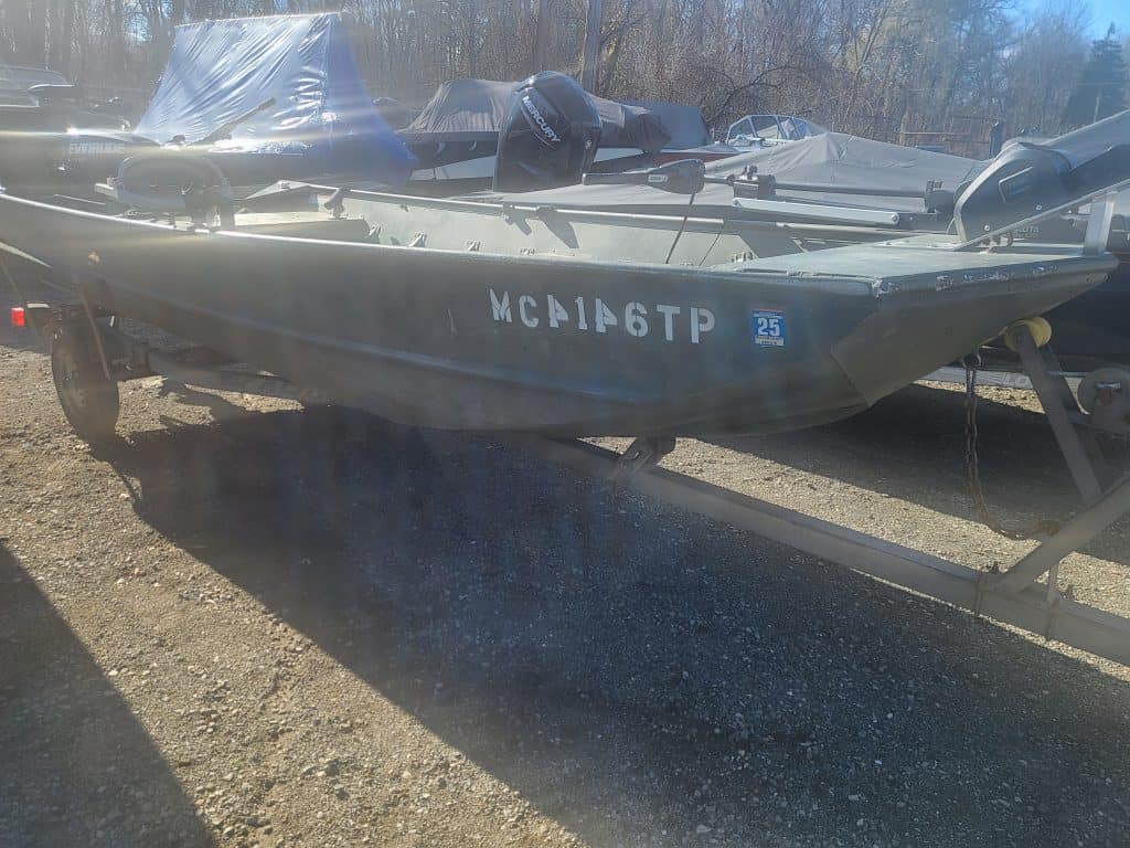 Used Lowe 15' 10 jon boat on trailer with outboard motor.