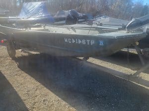 Used Lowe 15' 10 jon boat on trailer with outboard motor.