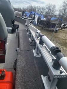 Boat trailer with mounted fishing rod holder and equipment.