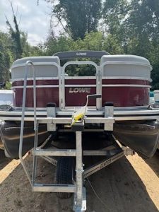 Lowe SS210 pontoon boat with red and white exterior on trailer.