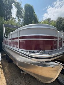 Lowe Boats SS210 pontoon boat with white and maroon exterior on trailer.