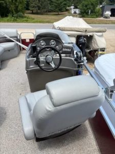 Boat dashboard with steering wheel and gauges for Lowe SS210 2017 model.