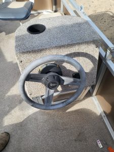Steering wheel and control panel at Camp & Cruise golf cart rental service.