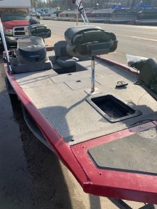 Interior view of a used Bass Tracker 17 boat with seating and storage.