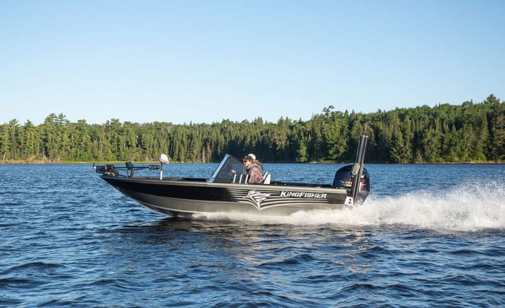 KingFisher Warrior Sport 1825 boat cruising on water with forest background.