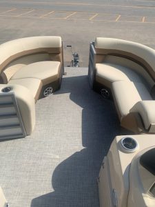 Lowe Boats SS210 pontoon boat interior with beige seating and cup holders.