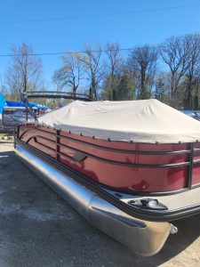 Lowe SS210 pontoon boat with protective cover and aluminum pontoons.