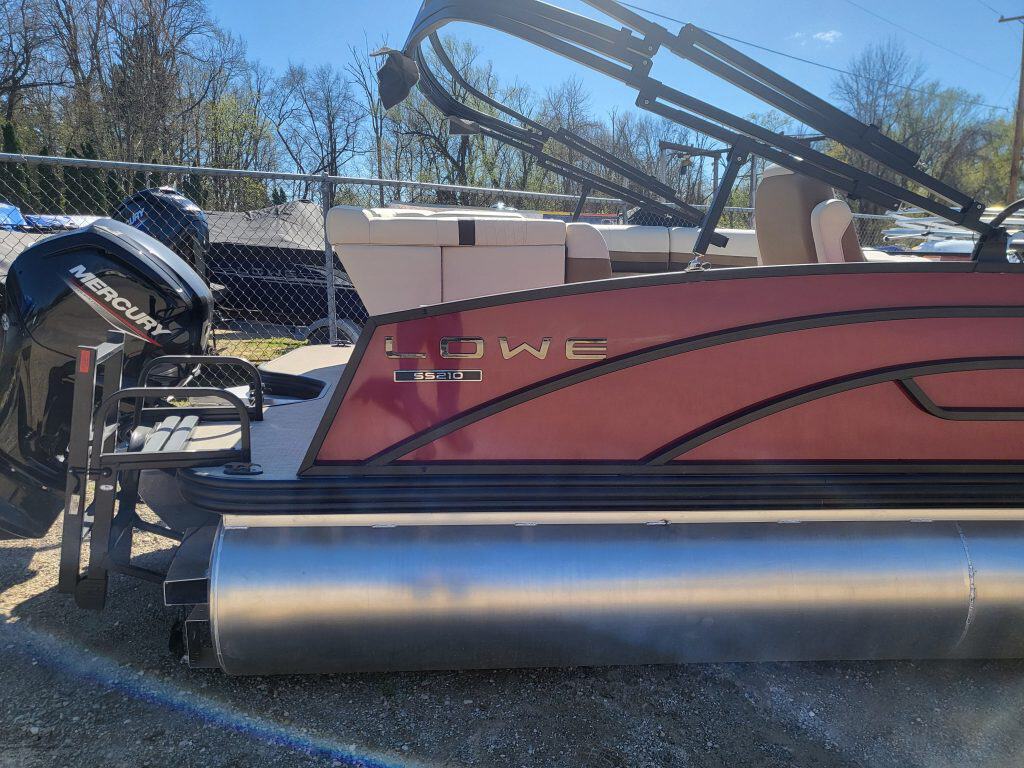 Lowe SS210 pontoon boat with Mercury outboard motor and beige seating.
