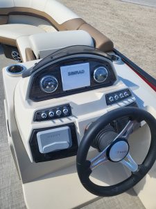 Boat dashboard with Simrad display and steering wheel for Lowe SS210 2022.