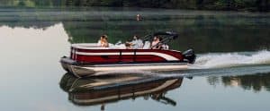 Lowe SS210 pontoon boat with people enjoying a ride on a calm lake.