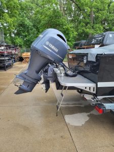 Yamaha outboard motor attached to boat on trailer in outdoor setting.