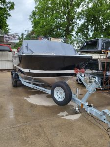 Boat trailer with boat on display at Camp and Cruise.
