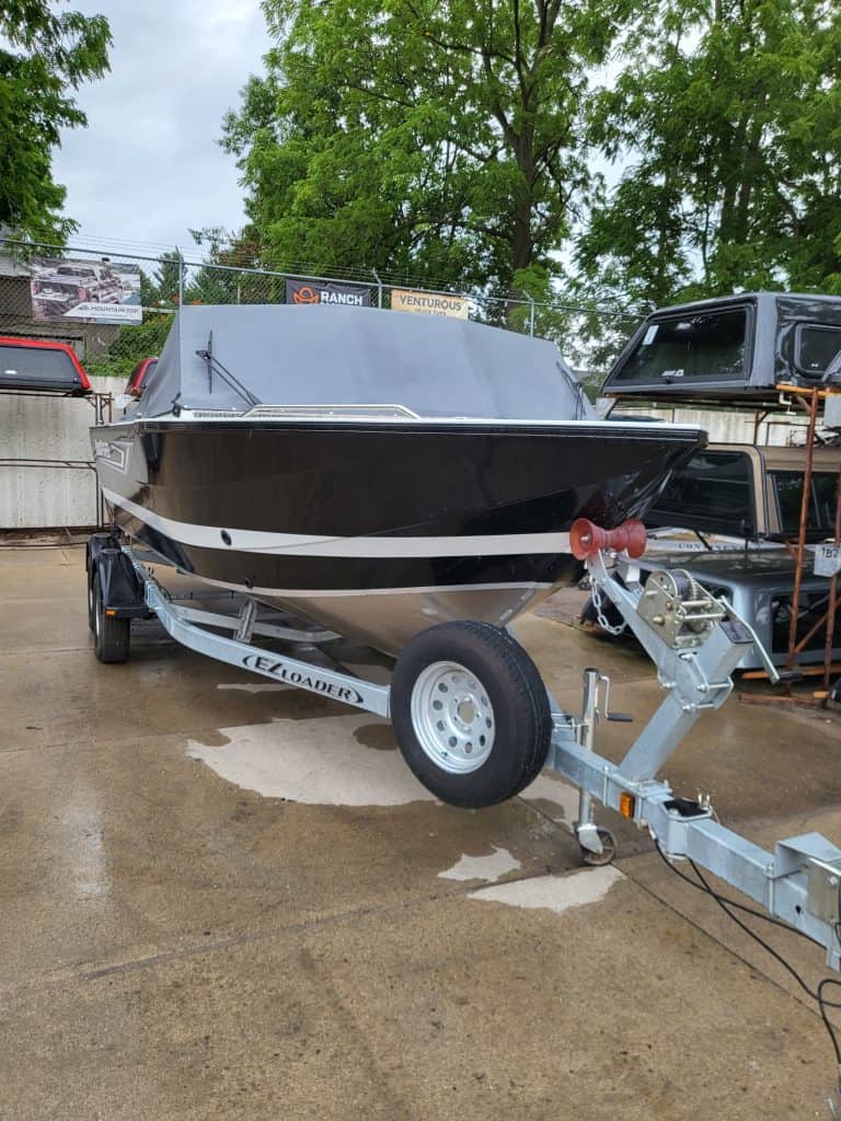 Boat trailer with boat on display at Camp and Cruise.