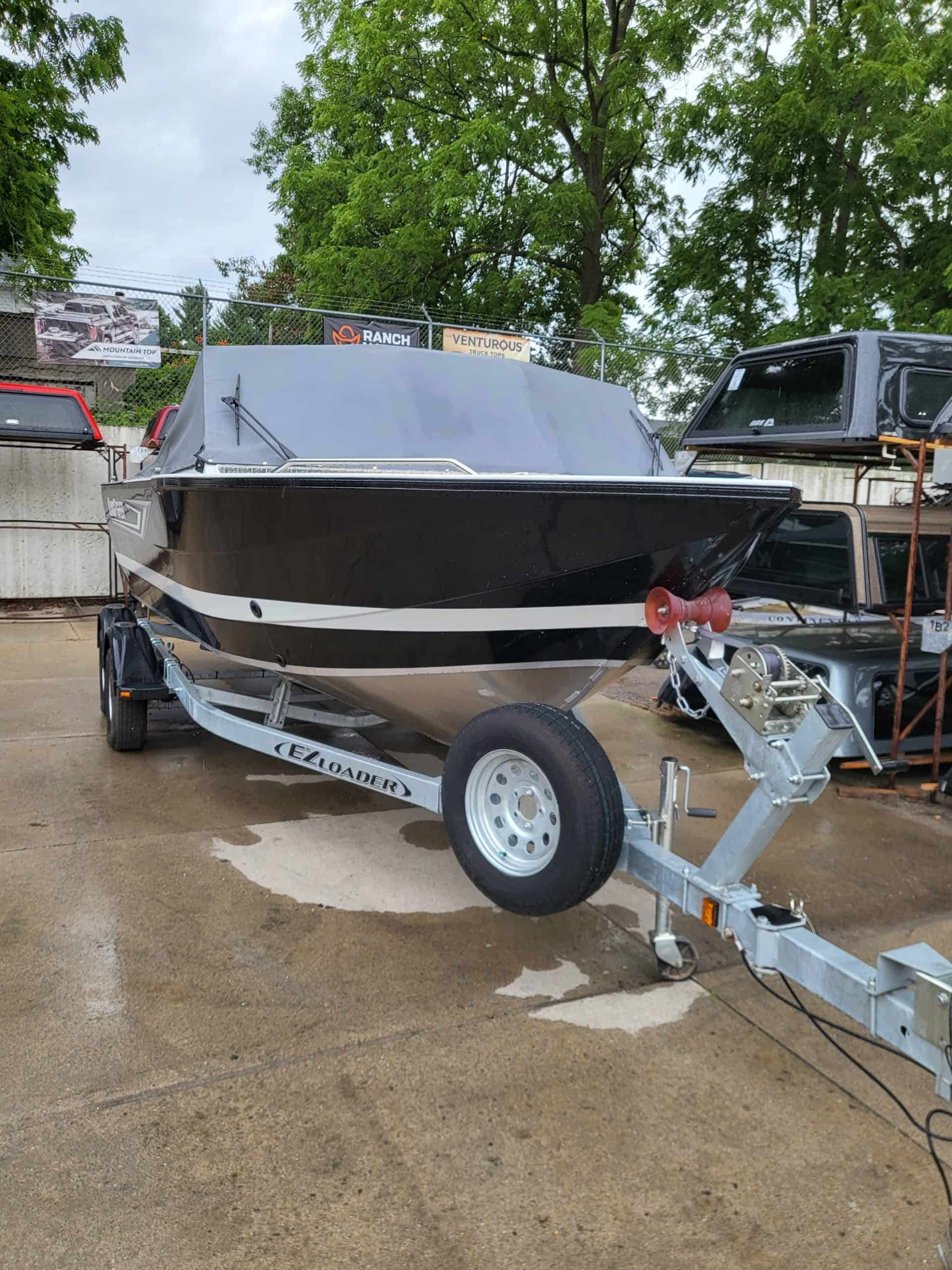 Boat trailer with boat on display at Camp and Cruise.