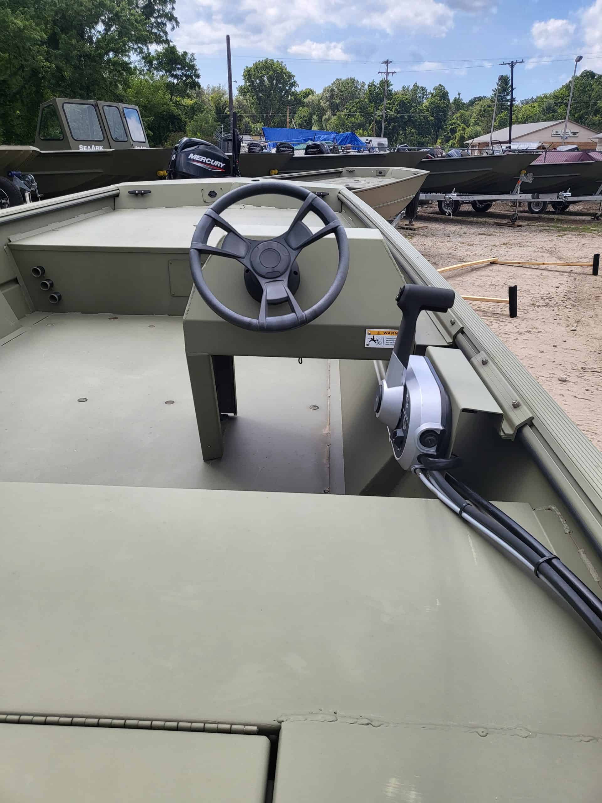 Close-up of boat steering wheel and throttle control on a boat.