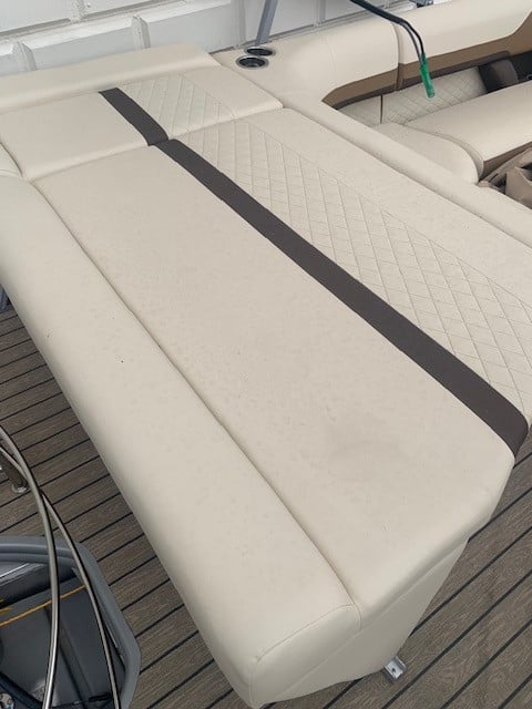 Close-up of boat seating upholstery with diamond stitching and black stripe.