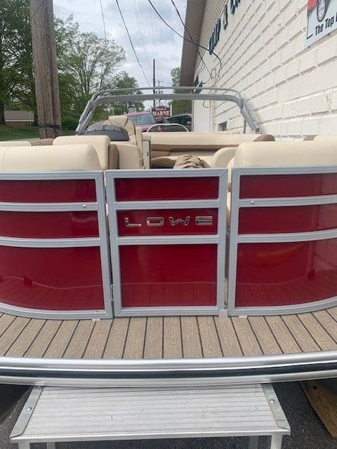 Lowe SS 210 pontoon boat with beige interior and red side panels.