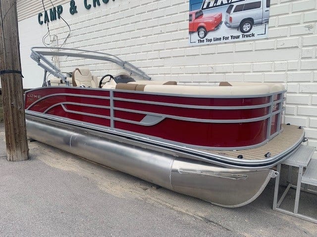 Lowe Boats SS 210 pontoon boat with Mercury engine on display.