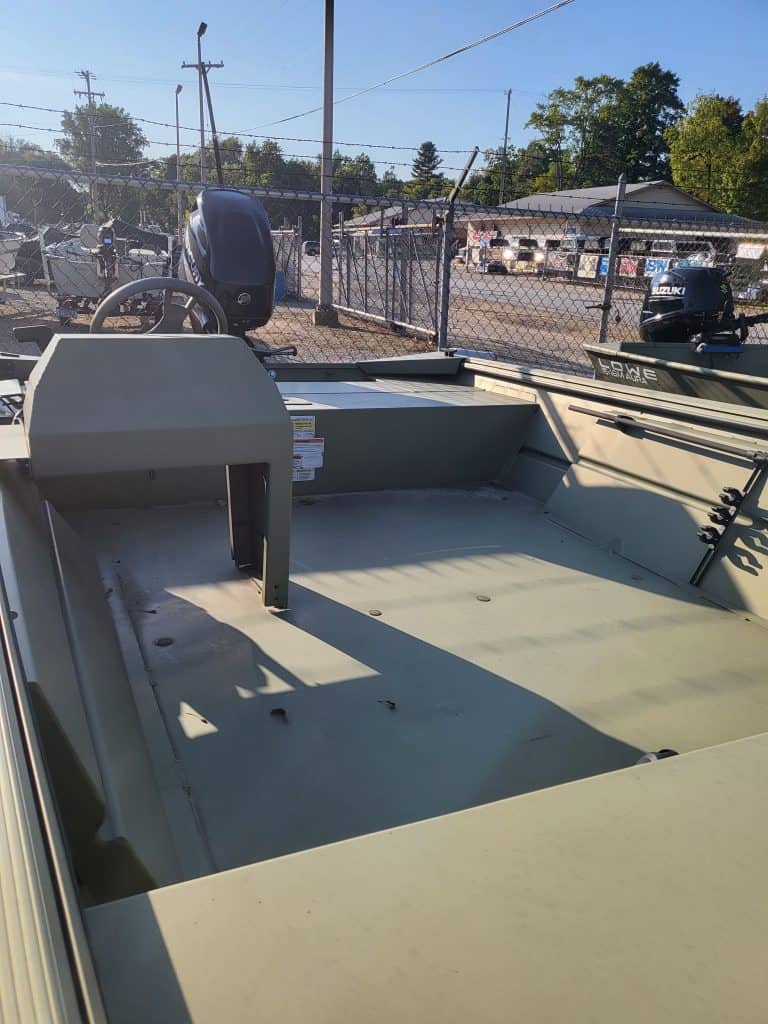 Close-up of a small fishing boat with outboard motor at Camp & Cruise.