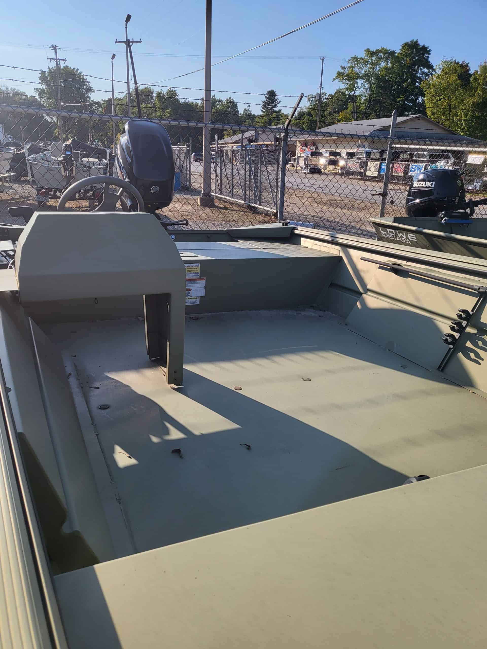 Close-up of a small fishing boat with outboard motor at Camp & Cruise.