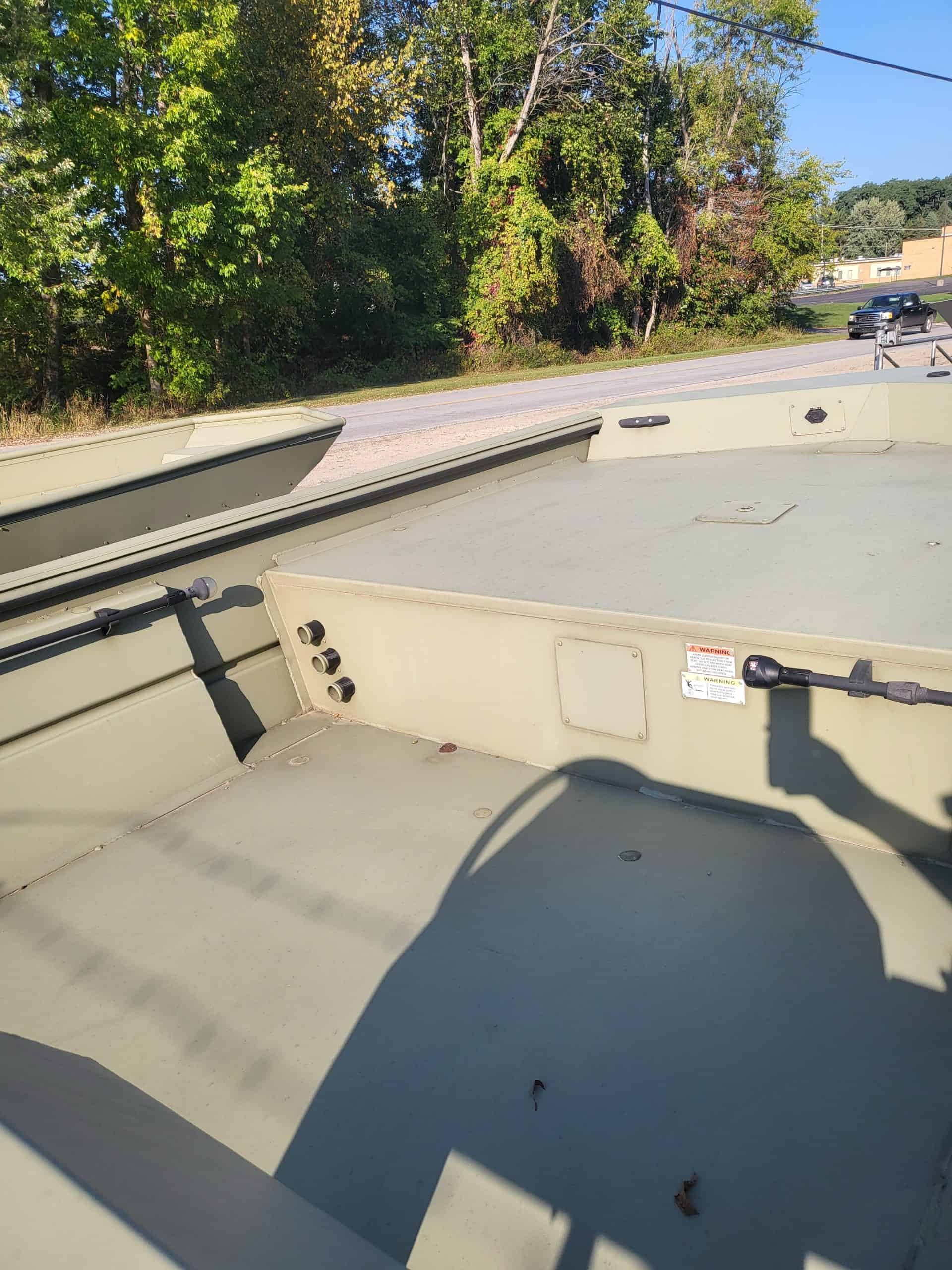 Close-up of boat deck at Camp & Cruise, showcasing outdoor storage and scenic natural background.