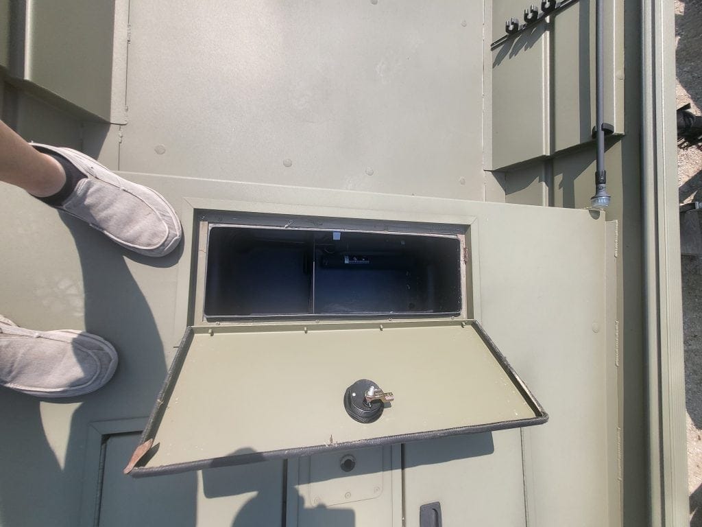 Open electrical panel access door on a utility box.