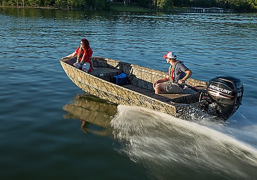 Family enjoying a boat ride on a calm lake with Mercury outboard motor.