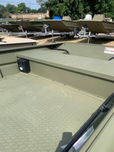 Close-up of boat deck with textured surface and electronic equipment.