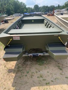 Aluminum boat with spacious interior and dual motor mounts for fishing or recreation.