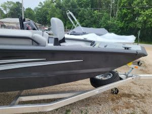 Black and gray SeaArk Easy 200 boat on trailer at dealership.