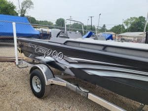 Black and gray SeaArk Easy 200 boat on trailer at dealership.
