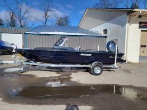 2023 SeaArk Protege boat on trailer outside building under blue sky.