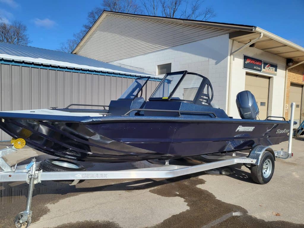 2023 SeaArk Protege boat on trailer outside dealership.