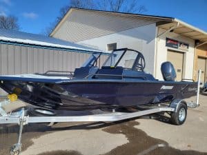 2023 SeaArk Protege boat on trailer outside dealership.