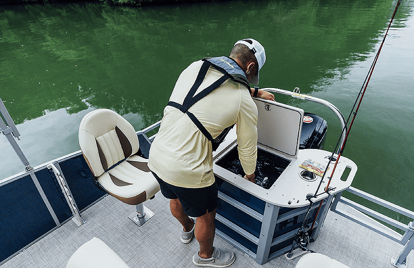 Man fishing from a Lowe Boats SF212W with fishing gear and water background.