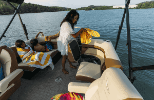 Family enjoying a boat ride on Lowe Boats SS230W with scenic water views.