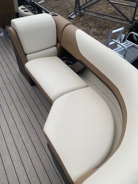 Comfortable boat seating with beige and white cushions on a pontoon boat.