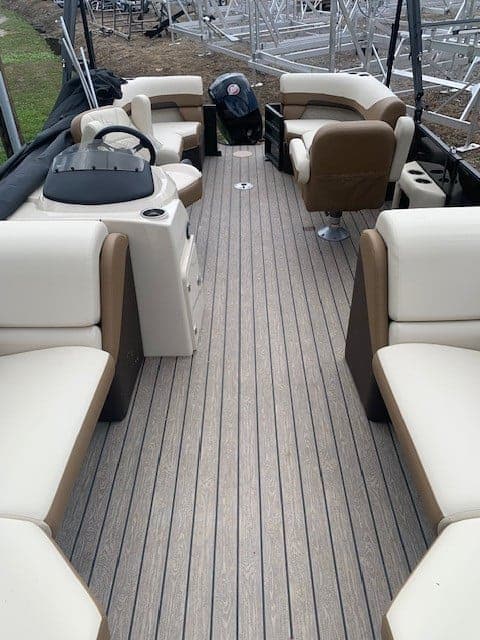 Interior view of Lowe Boats SS230W pontoon boat with seating and steering console.