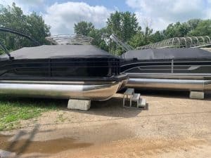 Two Lowe Boats SS230W pontoon boats outdoors on a grassy area.