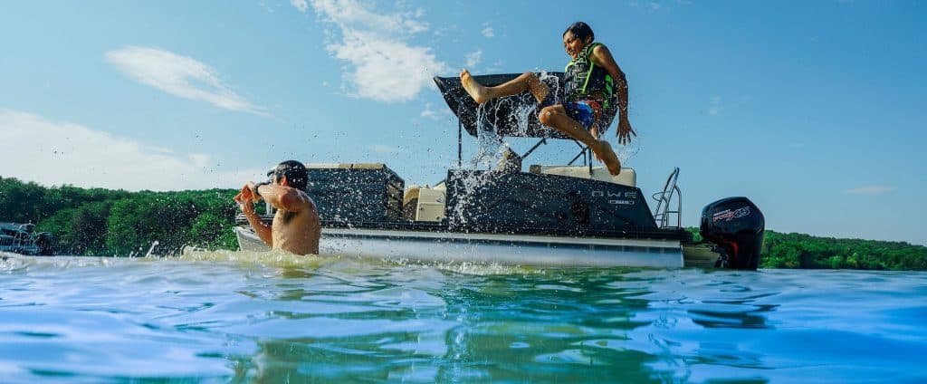 People enjoying water activities on a Lowe Boats SS230W boat.