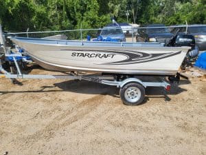 Starcraft Alaskan 13 TL DLX fishing boat on trailer with outboard motor.