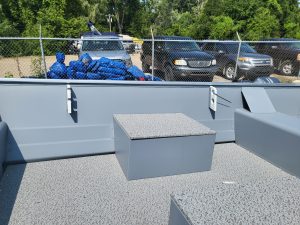 Boat deck with storage box and safety railing at Camp and Cruise.